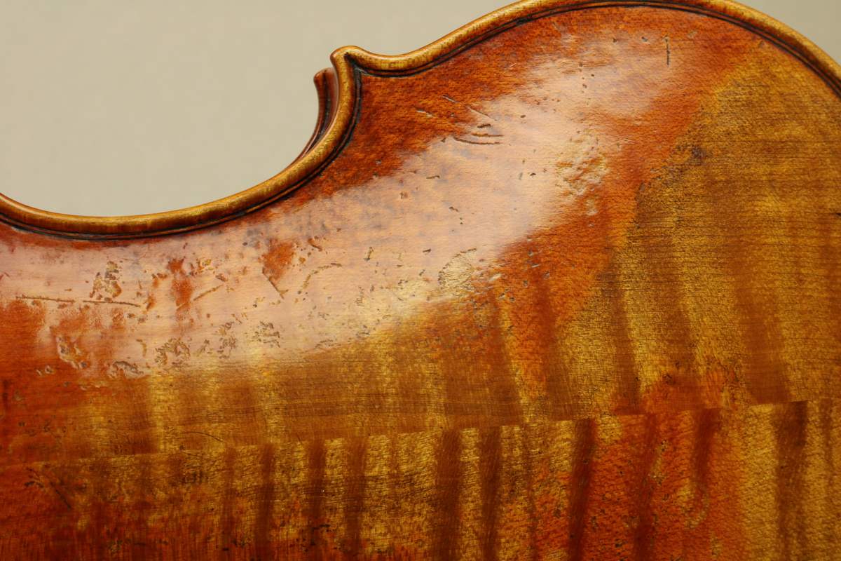 Varnish and edge work on the upper bout of a new violin