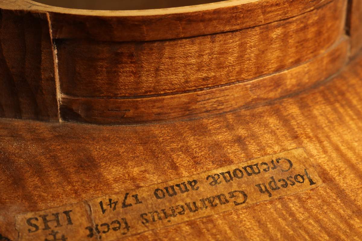 Maker’s label seen through the soundhole of a new instrument